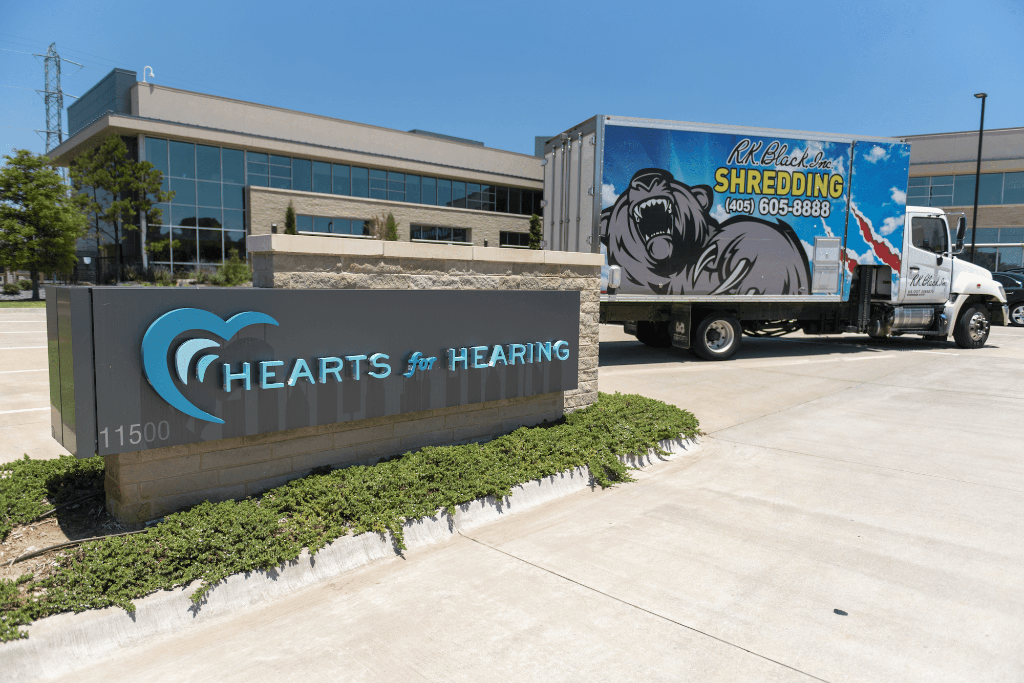 hearts for hearing sign with shred truck behind