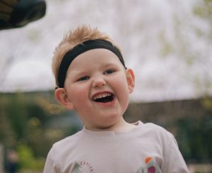 A young boy smiles on a playground