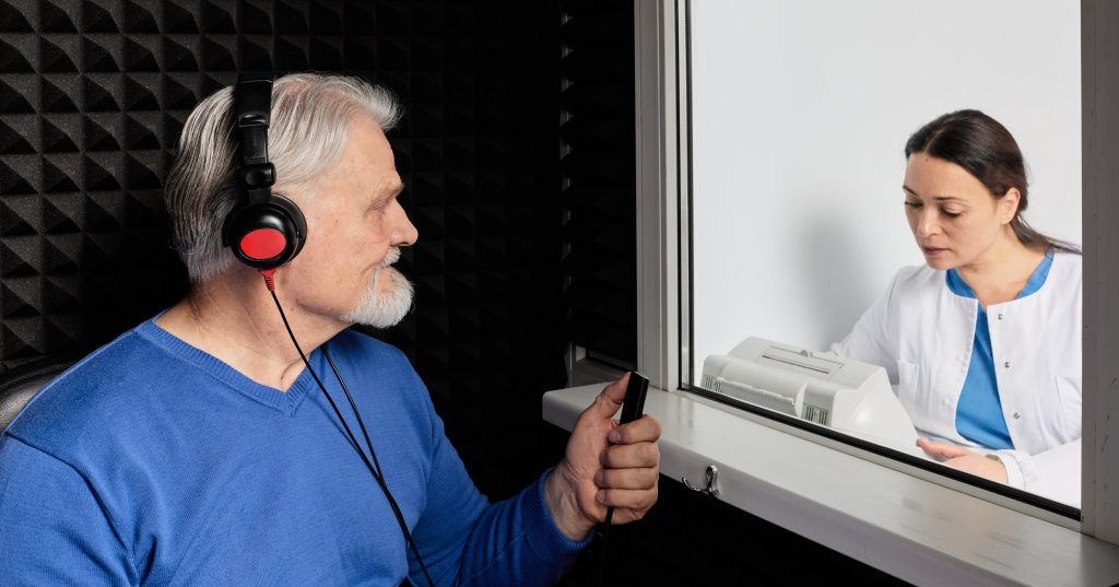 Older man getting hearing tested.