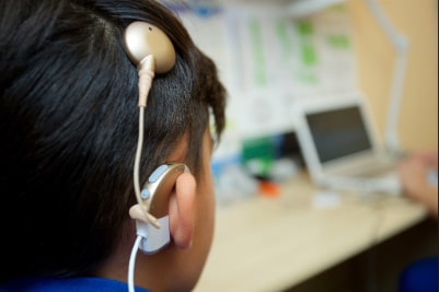 Boy with cochlear implant.