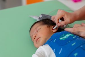 Newborn getting their hearing test.