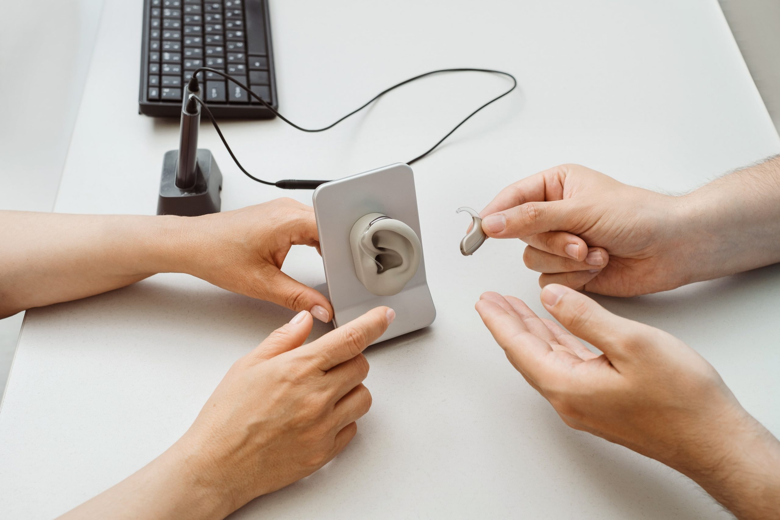 People holding hearing aids.